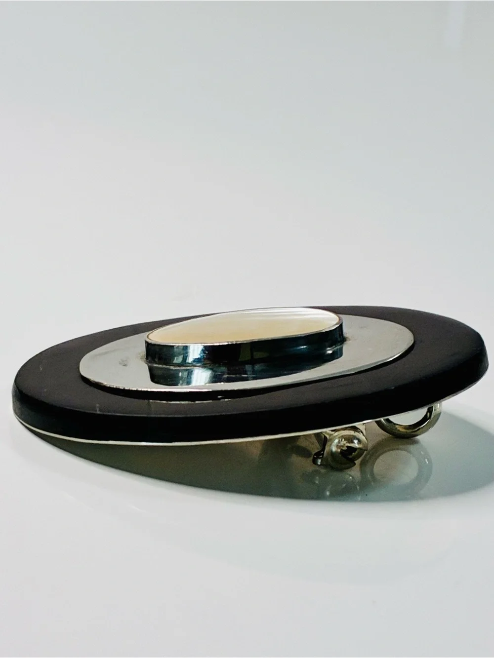 Elevated Simple Black and Silver Oval Brooch with Mother-of-Pearl Center Pendant